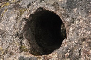 Hole in frozen lava caused when lava flowed around a living tree, which later rotted.